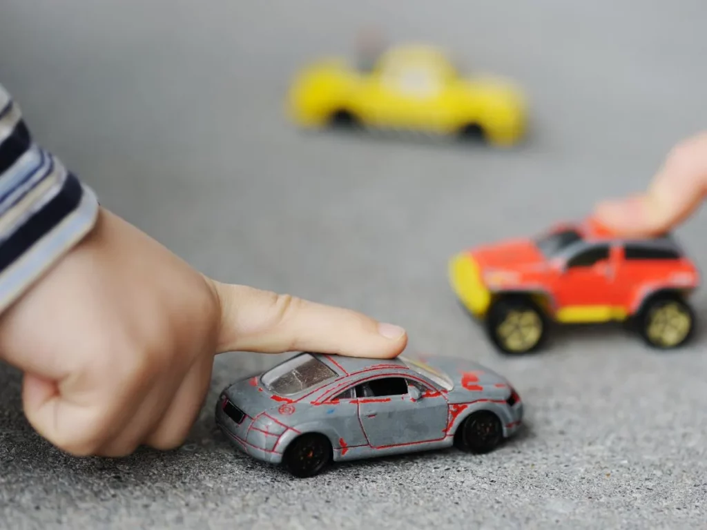 Kids playing with toy cars